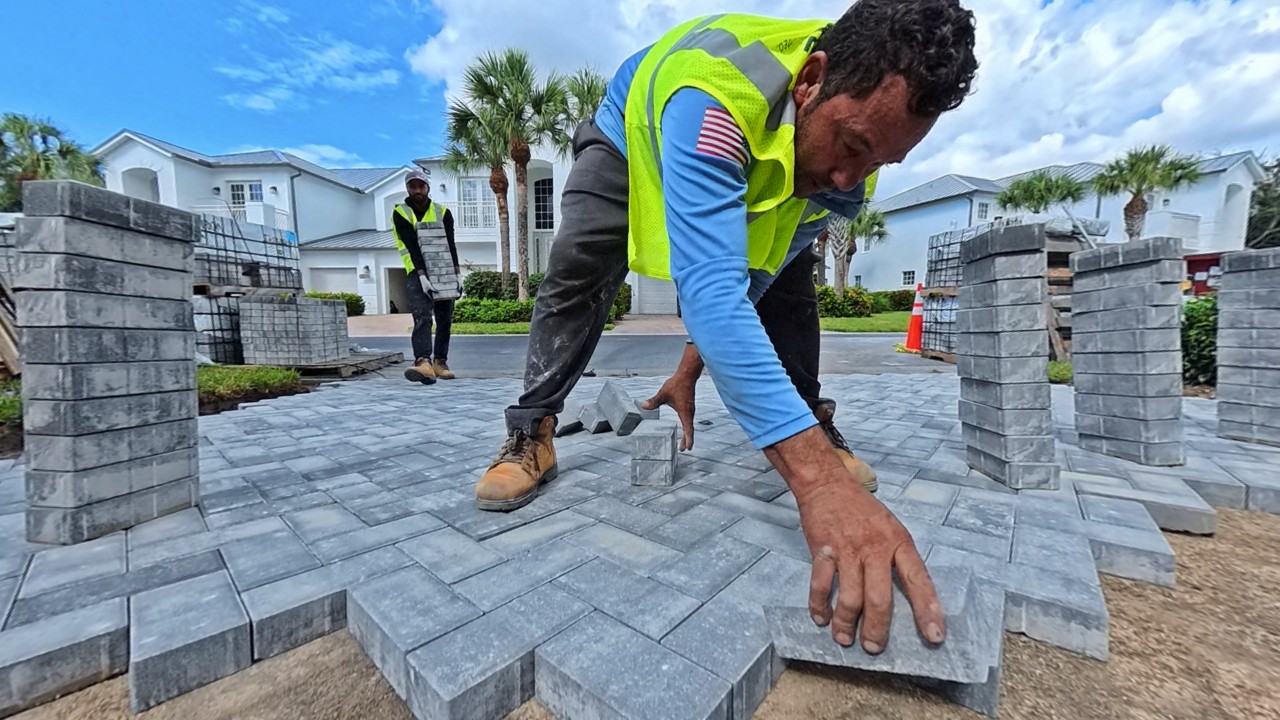 crew member installing paver driveway